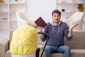 Young man looking after newborn at home