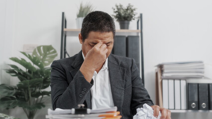 Tired, Elderly Old Senior Asian male businessman wearing formal suit ,confident professional bookkeeper doing bookkeeping, lawyer, stock market trader or broker.