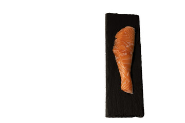 close-up of piece of fresh salmon with coarse salt on top on a rectangular slate plate transparent background, png with space for text zenithal picture