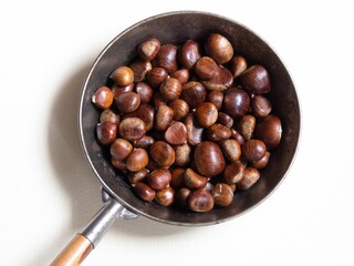 chestnuts in a rosting pan of metal