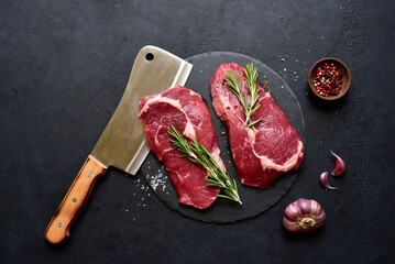 Raw organic rib eye steak with ingredients for making. Top view with copy space.