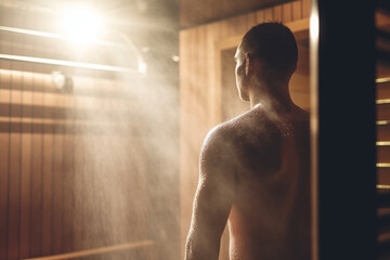Sweating it out: A view of a naked man's back in a steamy sauna