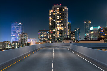 Fototapeta na wymiar Empty urban asphalt road exterior with city buildings background. New modern highway concrete construction. Concept of way to success. Transportation logistic industry fast delivery. Los Angeles. USA.