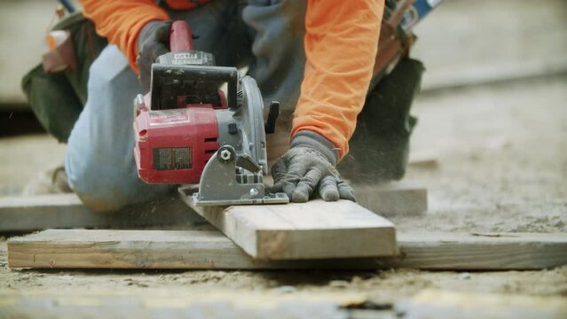 Beautiful view of an hardworking constructor using a drill for  making a building