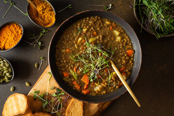 Healthy vegetarian lunches, brown lentil soup with tomatoes and carrots, potatoes and curry spices,...