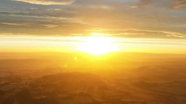 Aerial time-lapse footage of a sunrise over the Welsh countryside on a cold morning