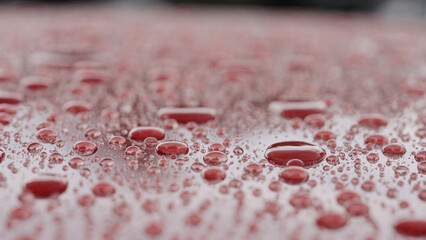 water beading on red car with hydrophobic coating