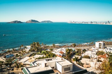 Fototapeta premium Aerial shot of a sea and buildings in Mazatlan with modern coastal buildings, Mexico
