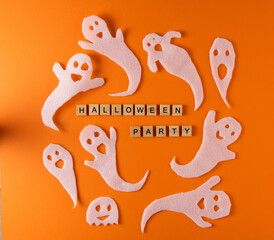 White ghosts craft for Halloween party. Wrapping paper ghost on orange background top view. Cartoon creepy Whisper. DIY hand made. Set boo characters. Word wooden letter phrase.