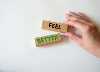 Feel better symbol. Wooden blocks with words Feel better. Businessman hand. Beautiful white background. Business and Feel better concept. Copy space.