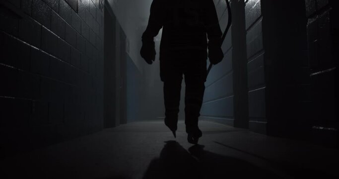 Closeup of a hockey player walking down the hallway in the arena for playing a game