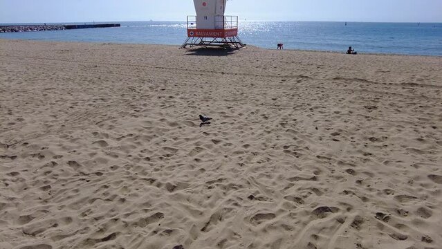 Calm beach day in Spain with a lifeguard tower and beautiful weather