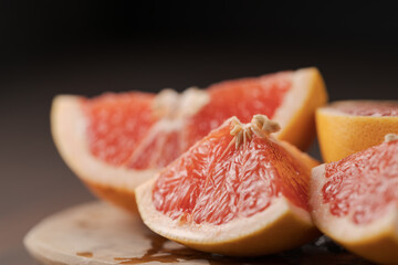 Fototapeta na wymiar Sliced grapefruit on wood board closeup