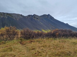 Autumn nature landscape with dry grass and hills in the background