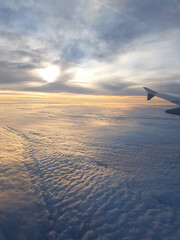 Aerial view from airplane window during sunrise.