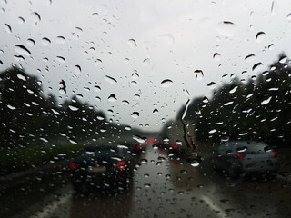 Abstract Traffic Jam in raining Day. Raindrops on a car windshield.