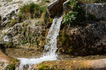 Water splashes in the air on a dark background. Shallow depth of field