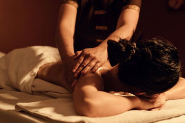 Relaxation woman back massage with masseur in cosmetology spa centre. - obrazy, fototapety, plakaty