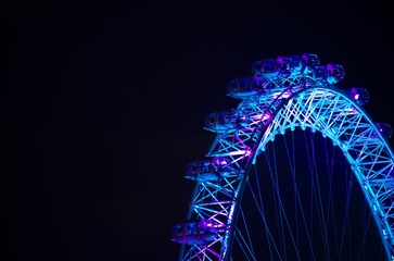 Drone shot of the colorful wheel of the London Eye at night - obrazy, fototapety, plakaty