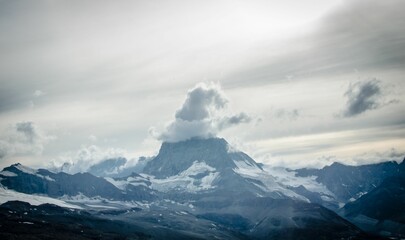 Scenic shot of a Mountain with the clouds on its peak in the shape of a hat, cool for background