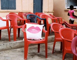 Closeup shot of red chairs and a pillow with kiss