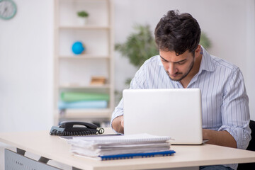 Young male employee working in the office