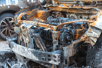 Abandoned burnt-out car after the explosion, ready for scrapping. The burnt-out interior of the car, a close-up of the fire, extinguishing the fire. A burnt-out car, due to a short circuit, arson. 