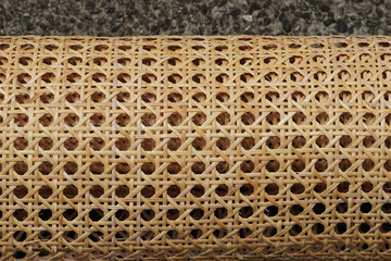 Top view of a roll of open mesh pre-woven cane (cane webbing).    
