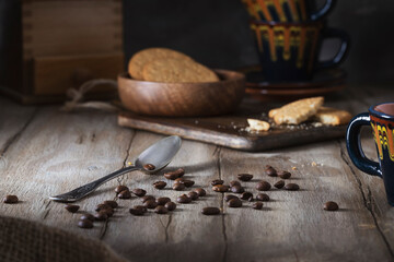 Roasted coffee beans scattered on a wooden table