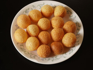 Closeup top view of hollow balls of deep fried pani puri, a famous street food in India.  