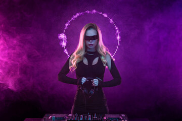 Music album cover design idea. Hot DJ in neon lights. Portrait of sexy TDJ at the night club party. Mixtape or book covers - download high resolution picture for your song or music clip.