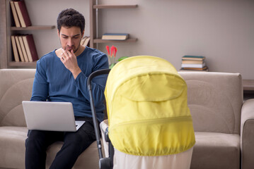 Young male contractor looking after baby at home