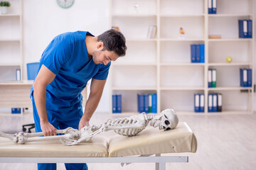 Young male doctor and skeleton patient at the hospital