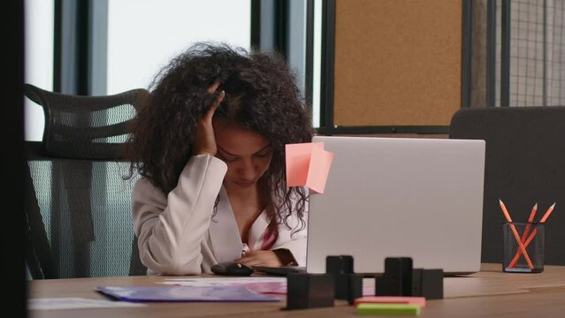 Tired African American woman fell asleep due to fatigue in office at her desk