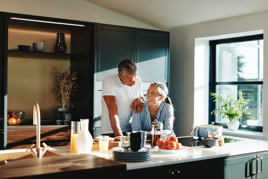 Smiling couple reading the newspaper together