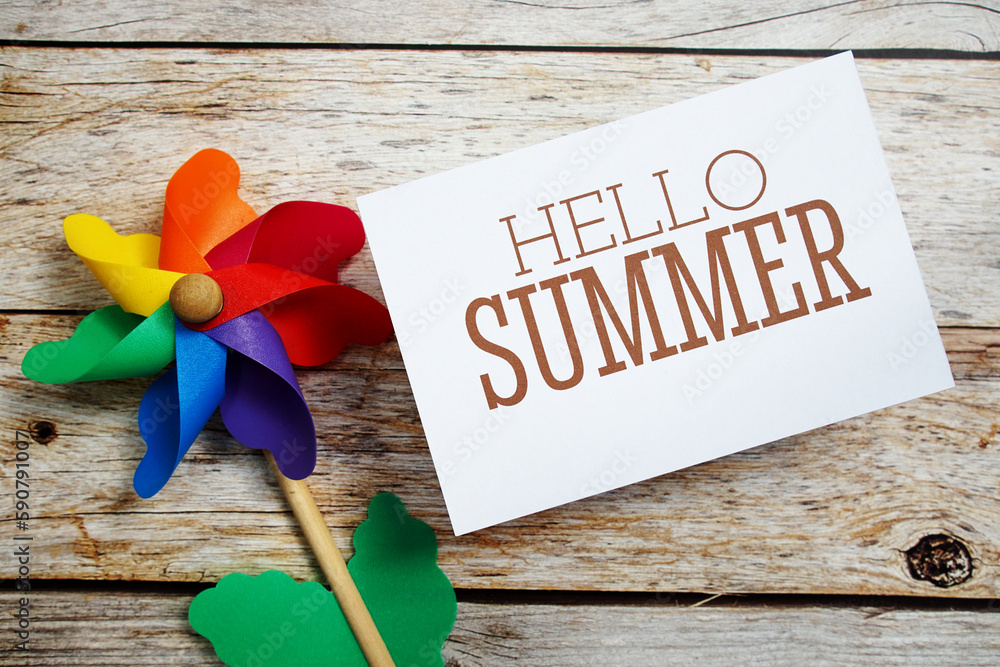 Poster hello summer text message with windmill on wooden background