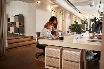 Young businesswomen using a laptop at work
