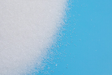 White sugar on blue background.