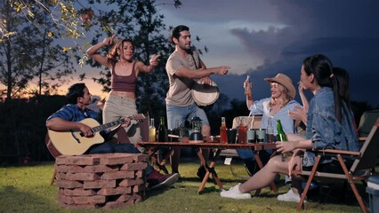Happy young friends traveler group having fun music and dancing together in camping party, Group of multiculturalism hipster people enjoying holiday vacation trip in campsite