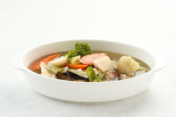 Capcay, stir fried vegetables with shrimp, meatballs and chicken. Served in white plate
