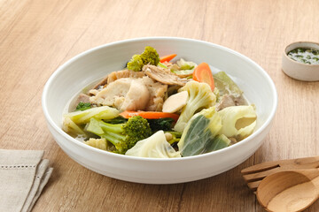 Capcay, stir fried vegetables with shrimp, meatballs and chicken. Served in white plate
