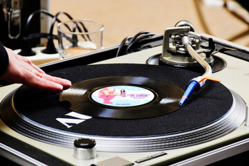 turntable closeup view. male dj hand mixing and spinning. music and disc jockey concept. old style...