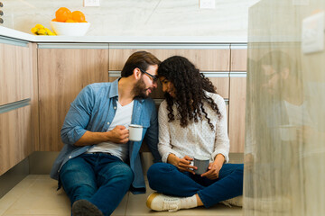 Fototapeta premium Loving young couple enjoying their coffee in the kitchen