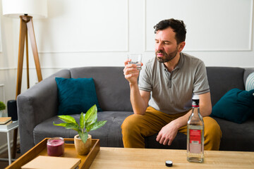 Sad upset man drinking alcohol feeling lonely