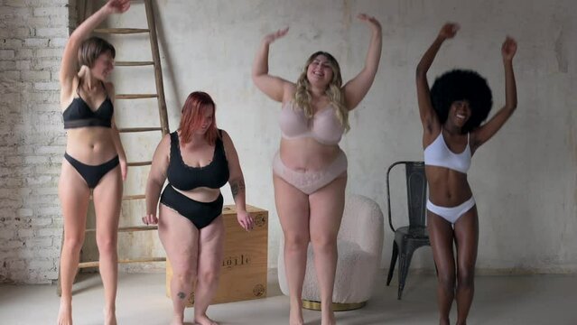 Body Positive and Acceptance, multiracial group of women with different body and ethnicity dancing and jumping pretend to be in a celebration party, plus size and skinny kind of female body concept