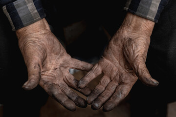 Dirty hands of working old elderly miner man, top view