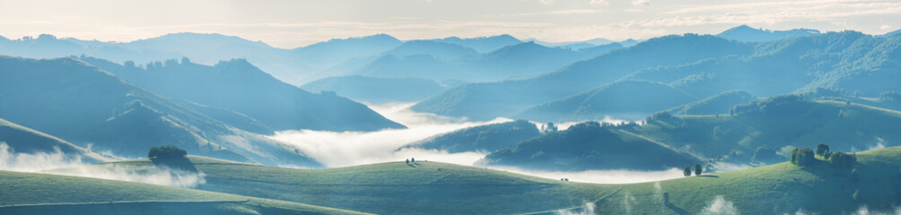 Panoramic morning landscape, fog and hills, spring greenery