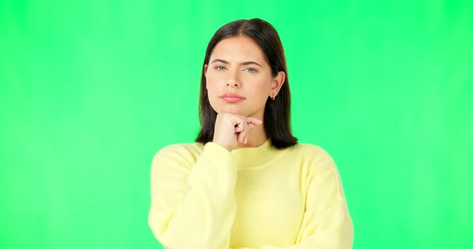 Face, thinking and consider with a woman on a green screen background in studio to decide her options. Idea, mind and contemplating with an attractive young female looking thoughtful on chromakey