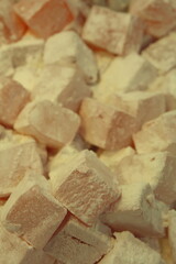 Traditional oriental sweet pastry cookies, nuts, dried fruits, pastilles, marmalade, Turkish desert with sugar, honey and pistachio, in display at a street food market.