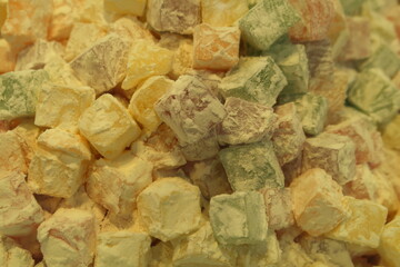 Traditional oriental sweet pastry cookies, nuts, dried fruits, pastilles, marmalade, Turkish desert with sugar, honey and pistachio, in display at a street food market.